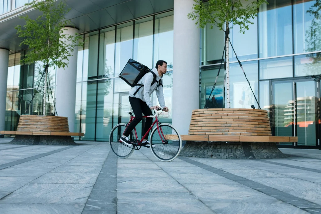 Gig worker riding bike as food delivery service