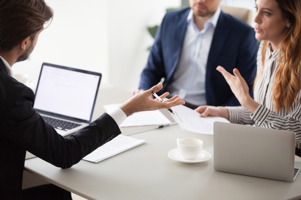 Insurance agent meeting clients in professional office setting