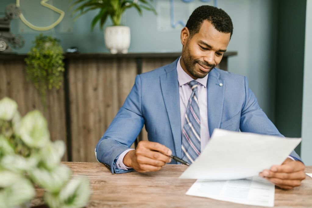 Insurance agent reading over strategies and policies in professional setting