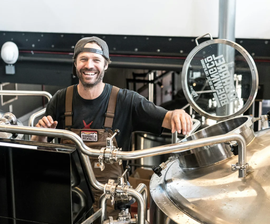 Small business owner with brewing machinery