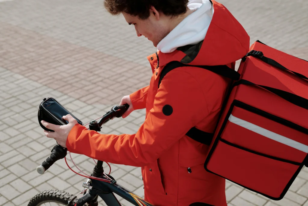 Gig worker checking phone during food delivery service